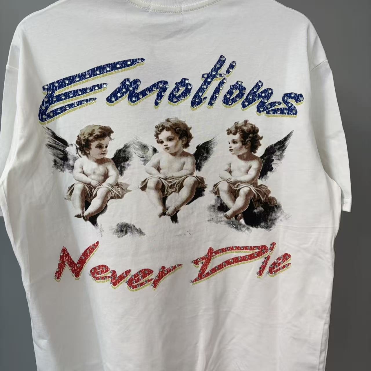 MIXED EMOTION Emotions Never Die Cherub Graphic T-Shirt — front