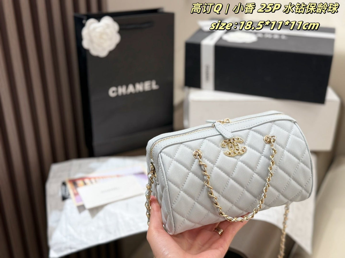 Chanel Quilted Bowling Bag with Jeweled CC Emblem — model