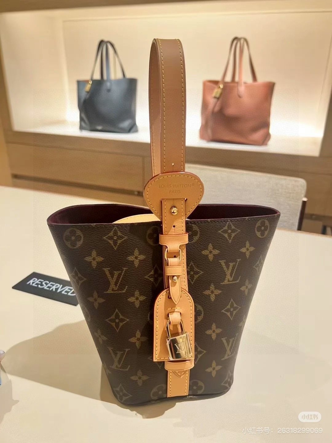 Louis Vuitton Monogram Buckle-Strap Bucket Bag — detail